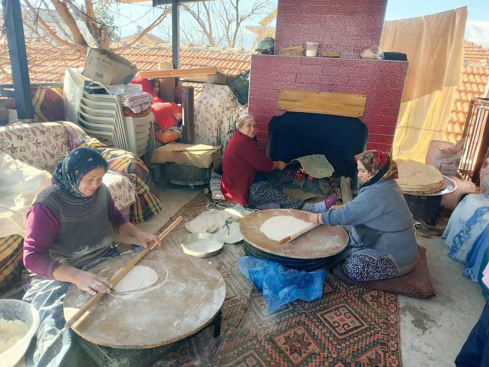 Denizli’nin Acıpayam ilçesinde ateşin başına geçen köy kadınları, depremzedelere gönderilmek üzere ekmek, pide, katmer, gözleme yapıyor.